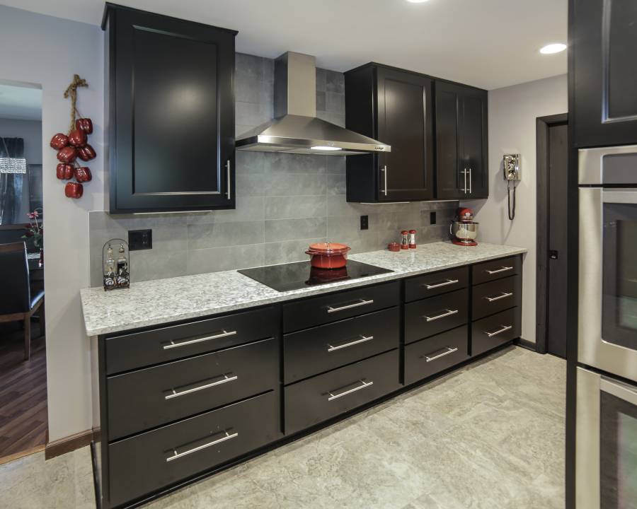 White quartz counter kitchen with dark wood