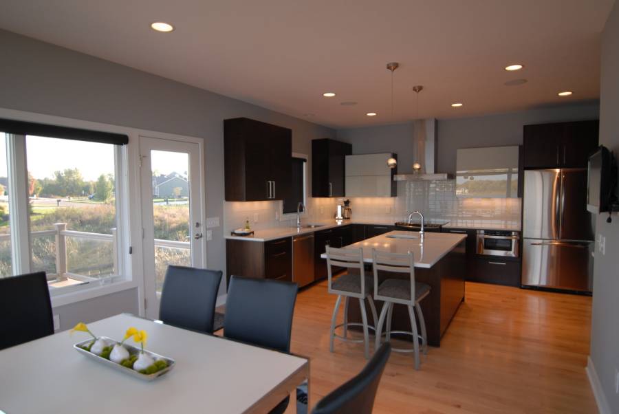 White quartz counter kitchen with dark wood