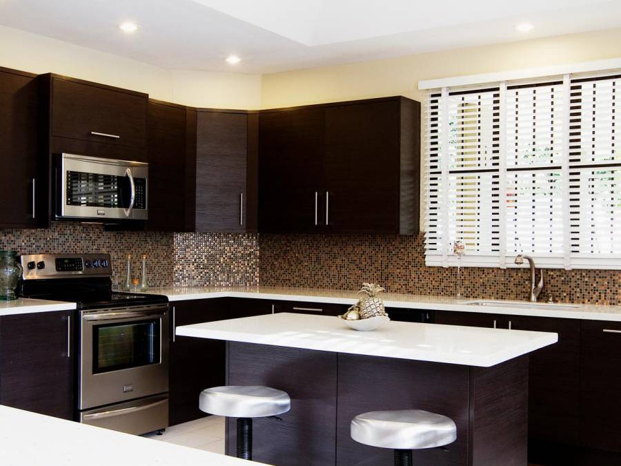 White quartz counter kitchen with dark wood