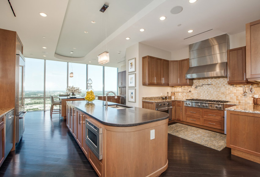 Contemporary kitchen with hardwood floors open to dining room