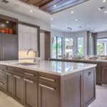 contemporary kitchen with limestone and rich wood cabinetry