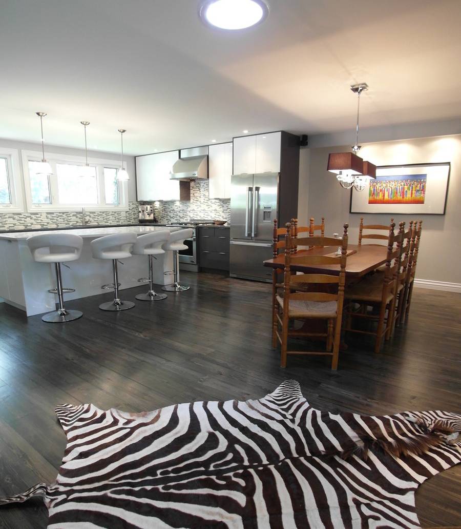 Contemporary kitchen with hardwood floors open to dining room