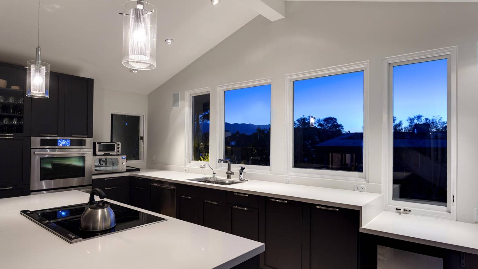 White quartz counter kitchen with dark wood