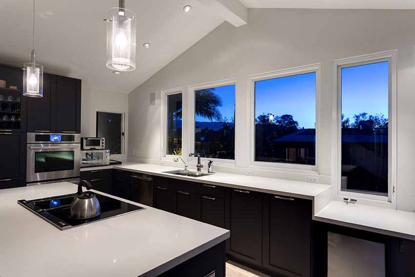 White quartz counter kitchen with dark wood