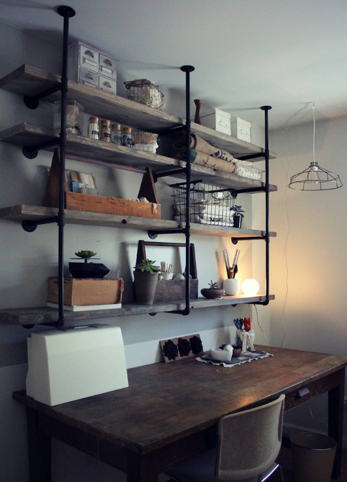 Example of industrial pipe shelving kitchen with vintage table