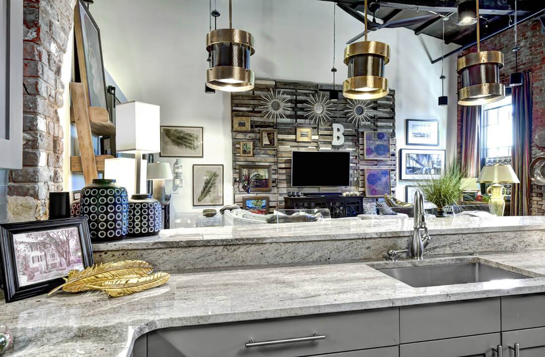 Ideal urban style loft kitchen with wall decor and connected living and dining areas